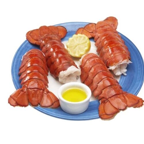 Jumbo lobster tails (8-10 oz.), perfectly cooked and served on a blue plate with melted butter and fresh lemon. These premium lobster tails feature tender, succulent white meat encased in a rich red shell, making them ideal for grilling, broiling, or steaming. A gourmet seafood choice for special occasions and fine dining.