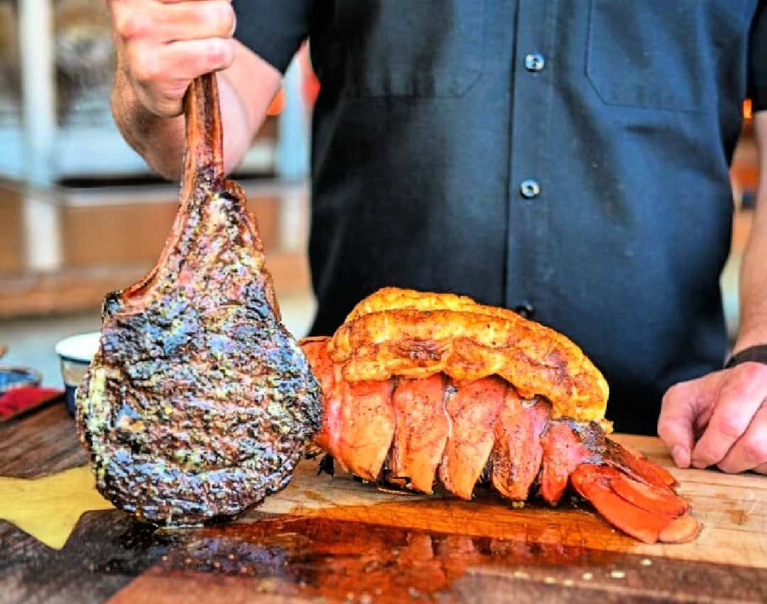 omahawk steak with massive lobster tail surf and turf dinner