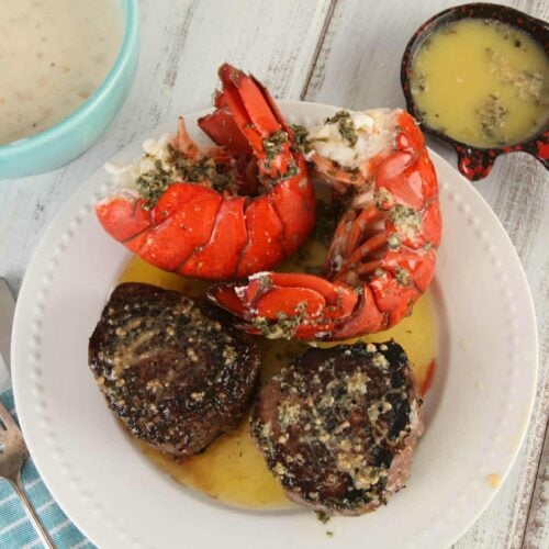 Surf and turf dish from Shop Back Bay, featuring perfectly grilled filet mignon and butter-drenched lobster tail, served with a side of creamy soup and garlic herb butter. This classic steak and seafood combination highlights premium cuts and fresh seafood, delivering a rich and indulgent dining experience.