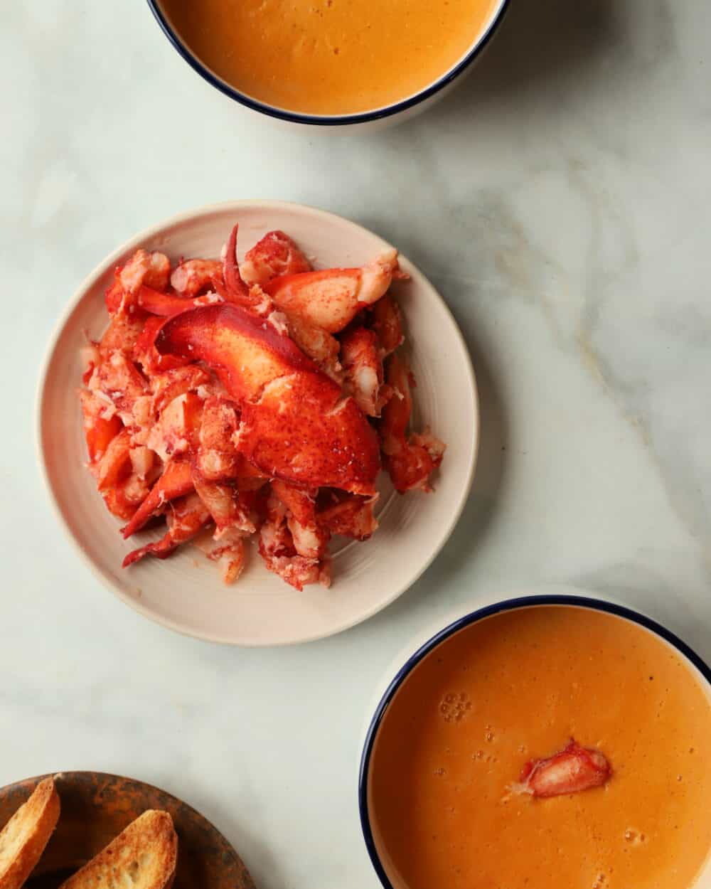 Close-up of fresh Maine lobster claw and knuckle meat with creamy lobster bisque