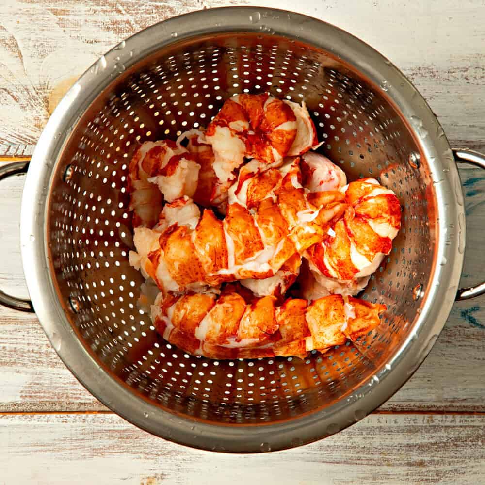 Cooked Maine lobster tail meat in a colander