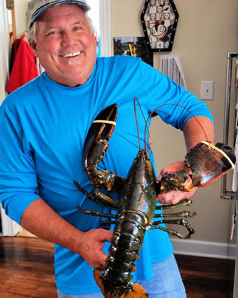 Smiling LobsterAnywhere customer holding a giant live lobster delivery